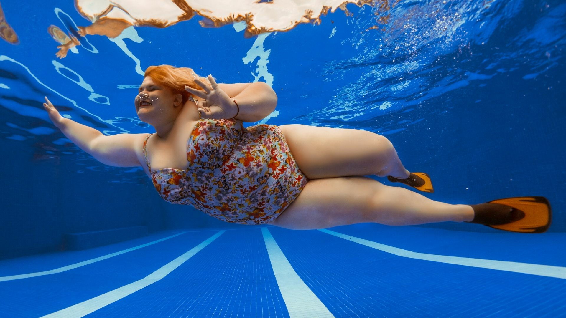 Mujer obesa mientras nada en la piscina