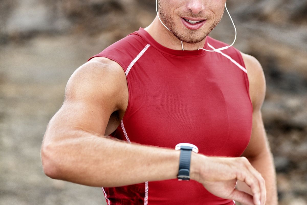 man measuring his heartbeat after doing cardio in the morning