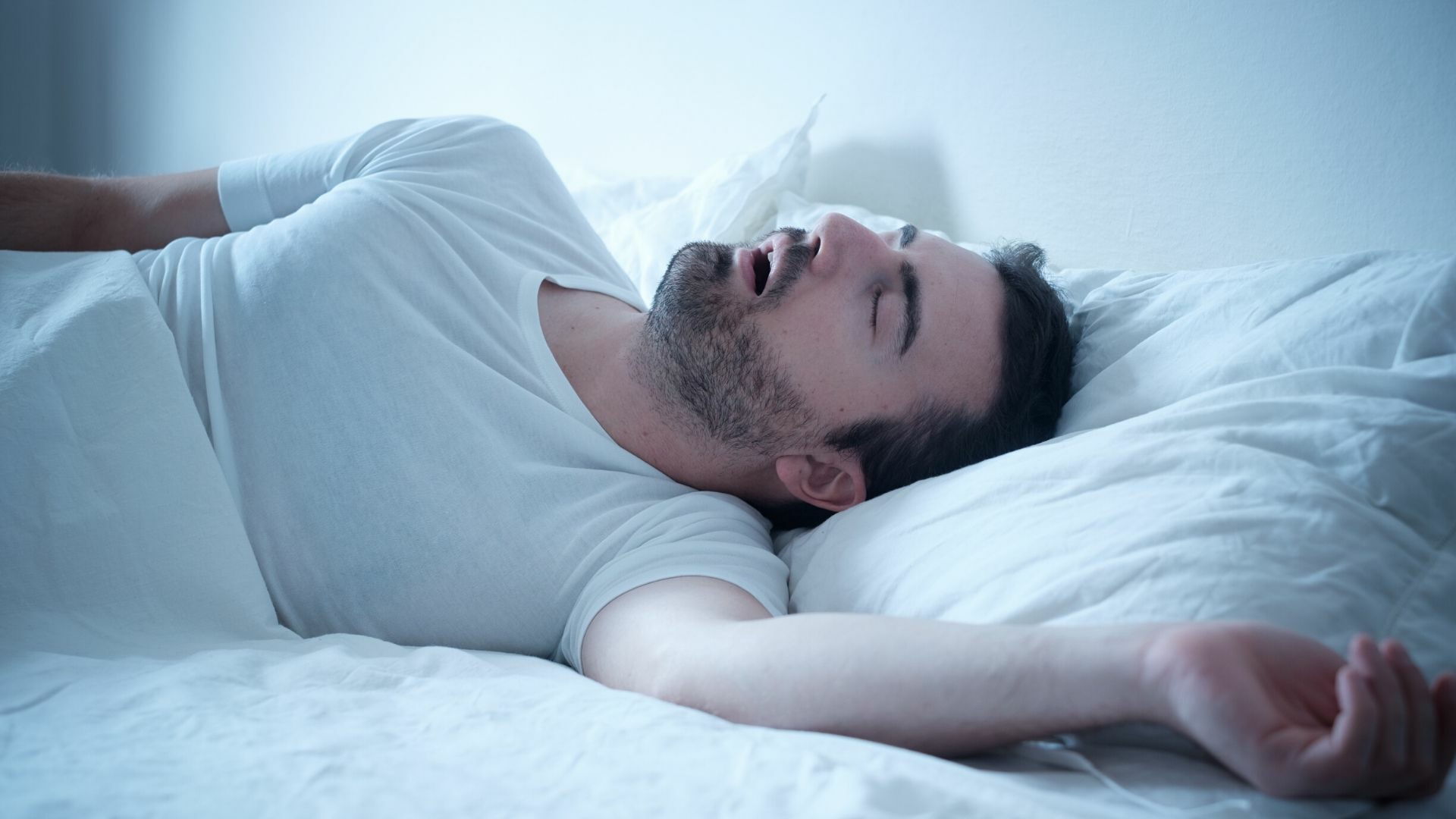 man sleeping in his bed